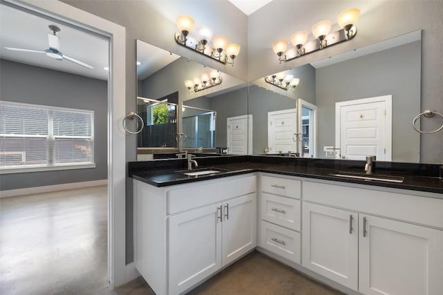 full bath with double vanity, a stall shower, baseboards, and a sink