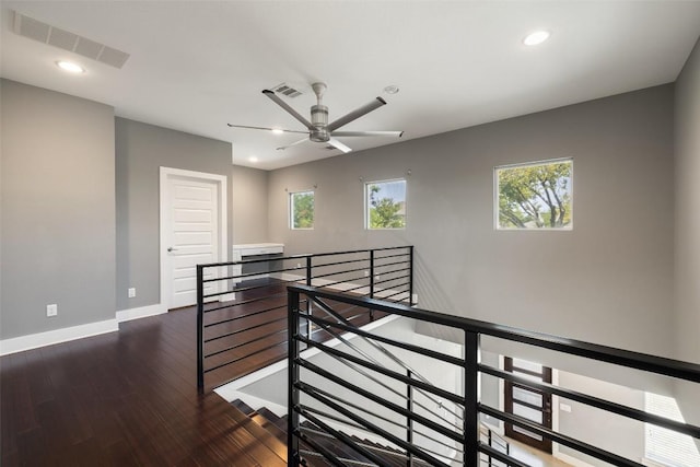 hall featuring a healthy amount of sunlight, visible vents, and an upstairs landing