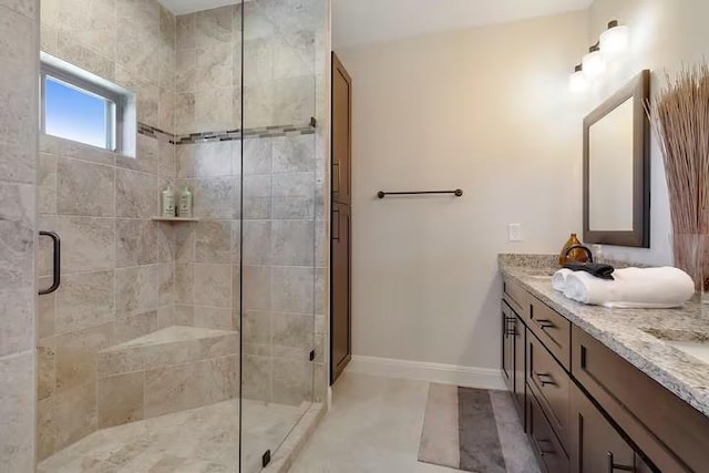 bathroom featuring tile patterned flooring, vanity, and a shower with shower door