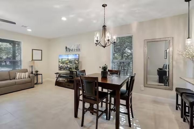 dining area with a chandelier and light colored carpet