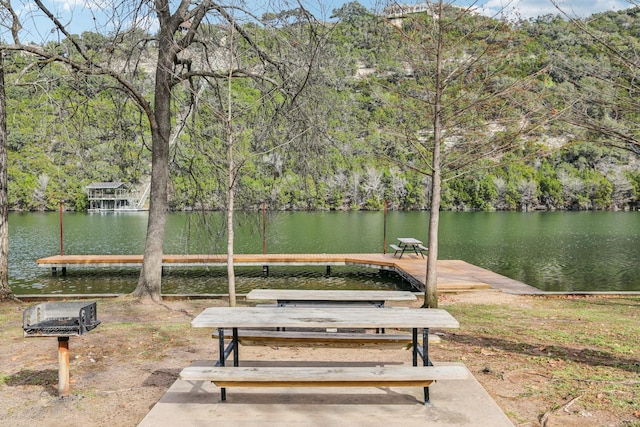 view of community featuring a water view and a boat dock