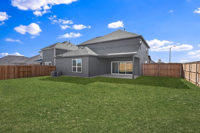 rear view of property with central air condition unit, a yard, and a patio