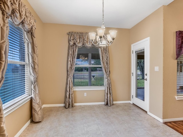 unfurnished dining area with a notable chandelier and light tile patterned floors