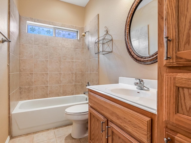 full bathroom featuring vanity, tiled shower / bath combo, tile patterned floors, and toilet