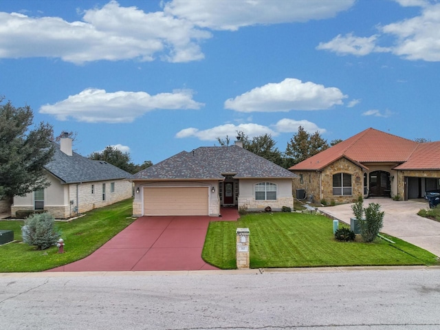 view of front of property with a garage and a front lawn