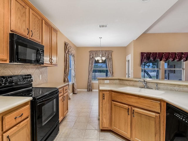 kitchen with sink, black appliances, pendant lighting, a chandelier, and light tile patterned flooring