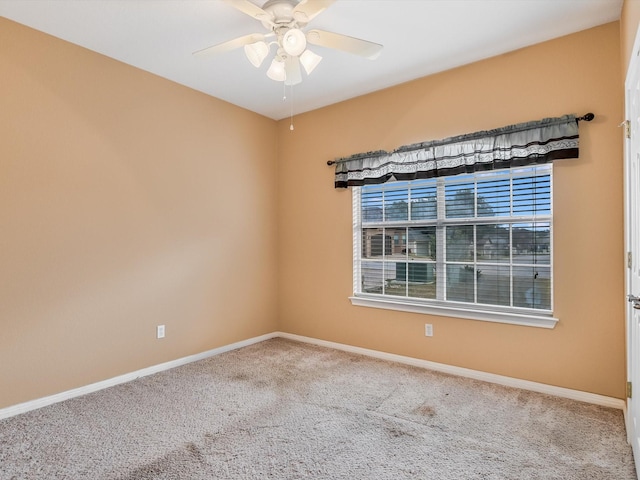 carpeted empty room featuring ceiling fan