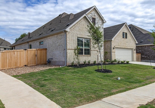 view of front of home featuring a garage and a front lawn