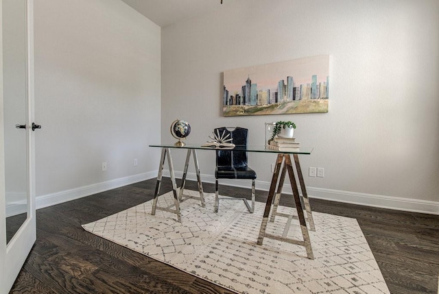 office space with dark wood-type flooring and vaulted ceiling