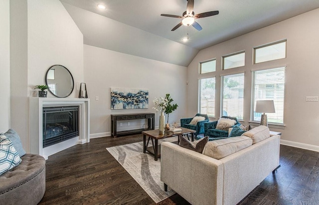 living room with lofted ceiling, ceiling fan, and dark wood-type flooring