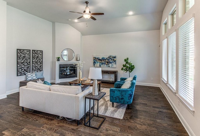 living room with ceiling fan, dark hardwood / wood-style floors, and lofted ceiling