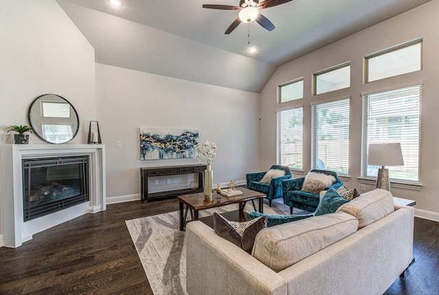 living room with ceiling fan, dark wood-type flooring, and vaulted ceiling