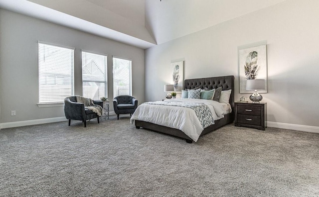 bedroom featuring carpet flooring and high vaulted ceiling