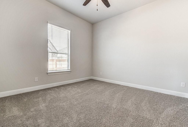 carpeted spare room featuring ceiling fan