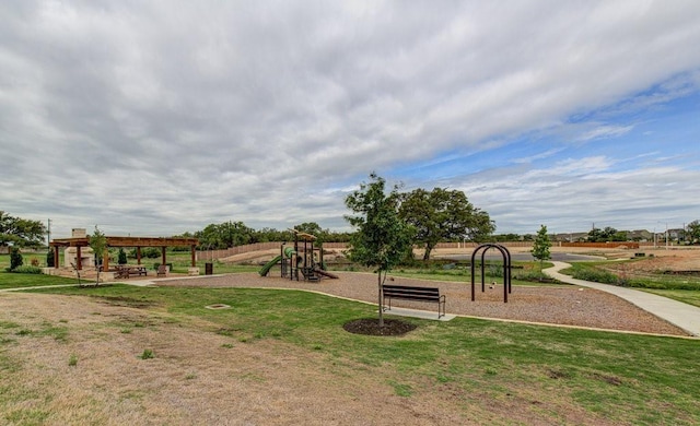 view of jungle gym featuring a lawn and a pergola