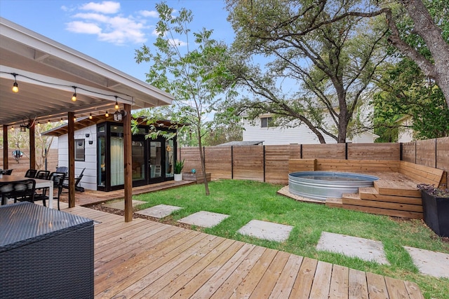 wooden terrace with a yard and a swimming pool