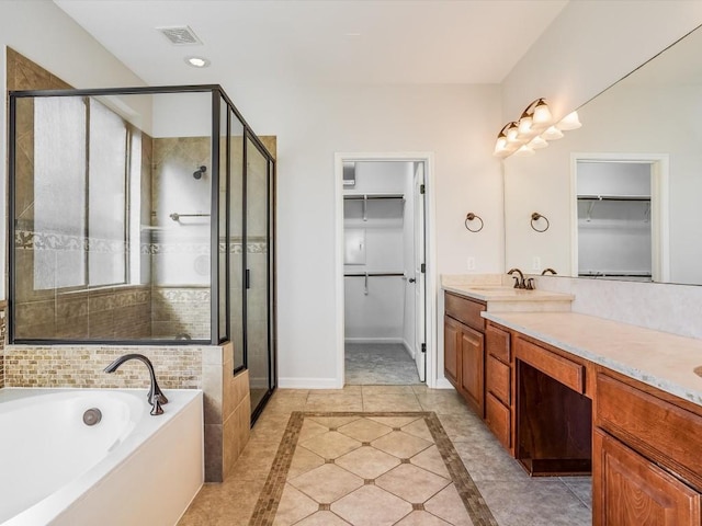 full bathroom with a stall shower, baseboards, visible vents, a garden tub, and vanity