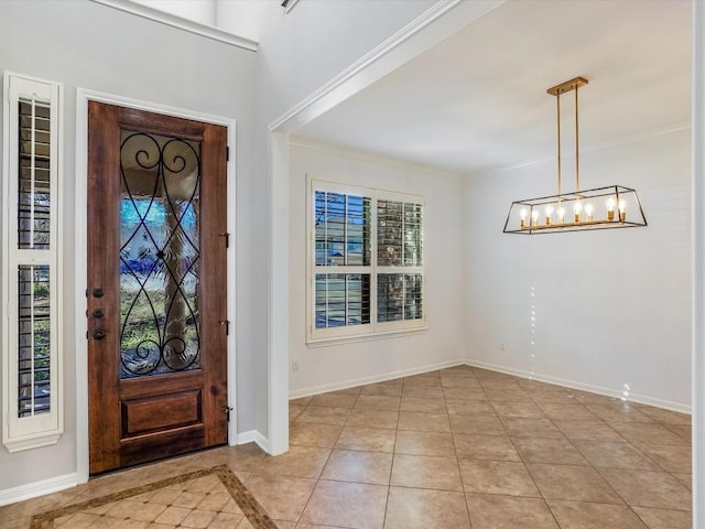 entrance foyer with light tile patterned floors, a chandelier, beverage cooler, baseboards, and crown molding