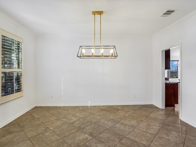 tiled spare room with a healthy amount of sunlight, visible vents, and crown molding