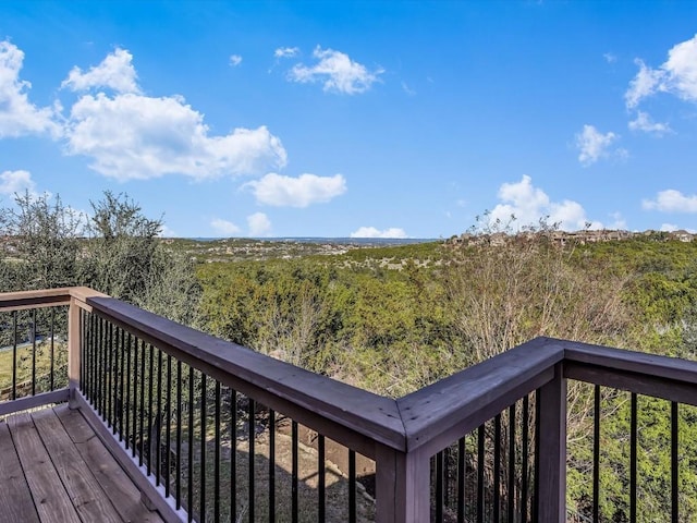 wooden terrace with a view of trees