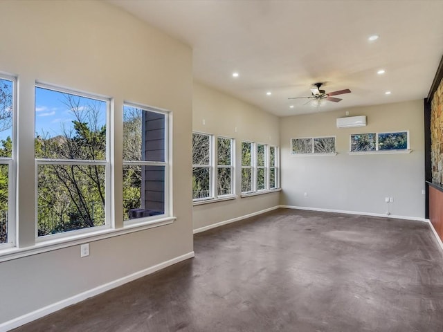 spare room with concrete flooring, recessed lighting, a ceiling fan, baseboards, and a wall mounted AC