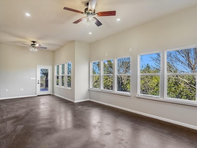 spare room featuring concrete flooring, ceiling fan, recessed lighting, and baseboards