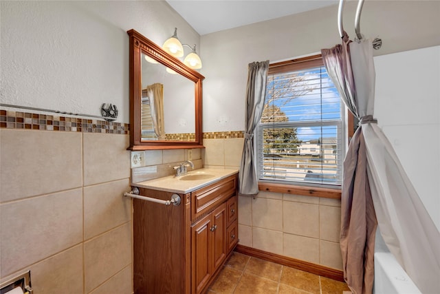 bathroom featuring tile patterned floors, vanity, shower / bath combination with curtain, and tile walls