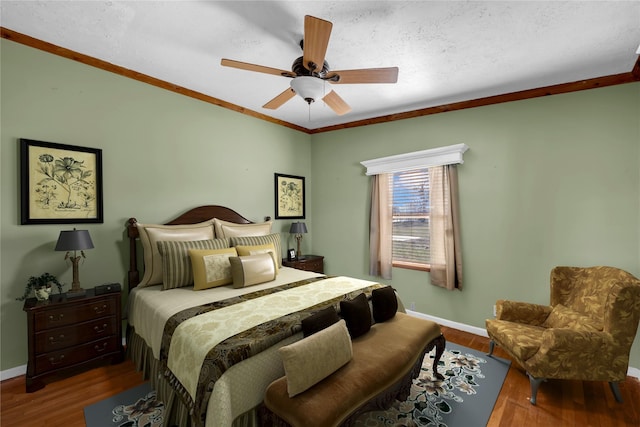 bedroom with hardwood / wood-style floors, a textured ceiling, ceiling fan, and crown molding