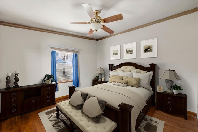 bedroom featuring ceiling fan, dark hardwood / wood-style flooring, and crown molding