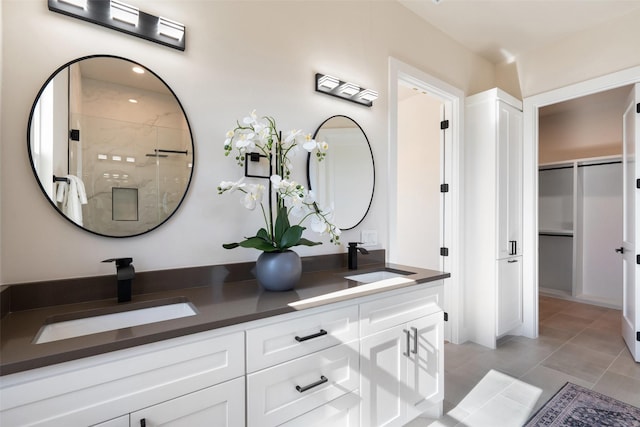 bathroom featuring walk in shower, tile patterned floors, and vanity