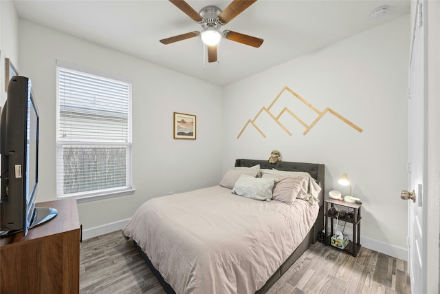 bedroom with hardwood / wood-style floors and ceiling fan