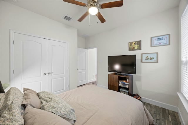 bedroom featuring hardwood / wood-style flooring, ceiling fan, and a closet