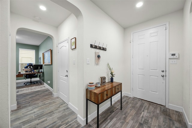 entryway with dark hardwood / wood-style flooring