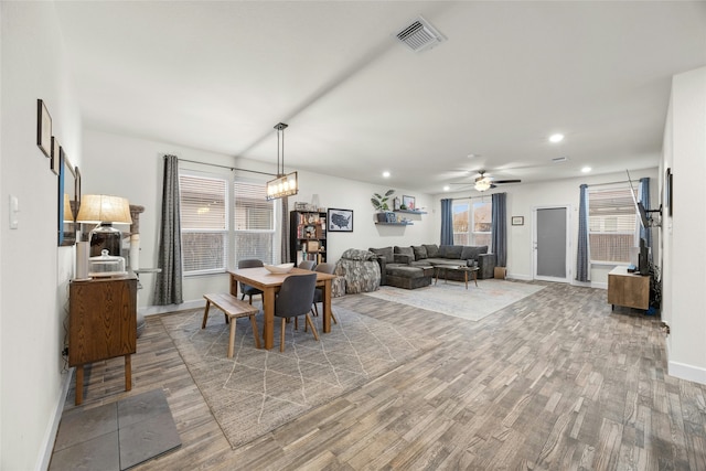 dining space with hardwood / wood-style flooring, ceiling fan, and a healthy amount of sunlight