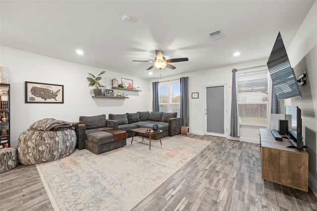 living room with hardwood / wood-style floors and ceiling fan