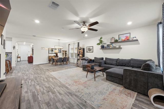 living room featuring hardwood / wood-style flooring and ceiling fan