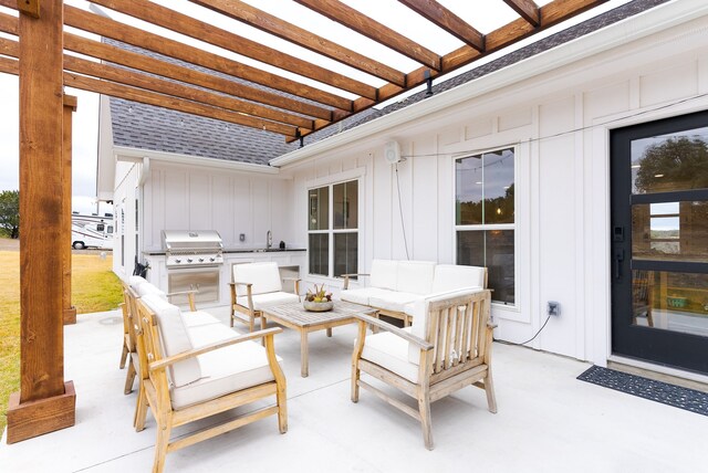 view of patio / terrace featuring a pergola, grilling area, an outdoor living space, and exterior kitchen