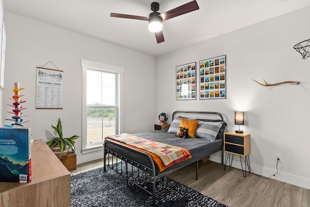 bedroom with ceiling fan and hardwood / wood-style floors