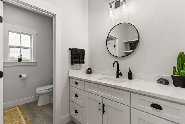 bathroom featuring hardwood / wood-style floors, vanity, and toilet