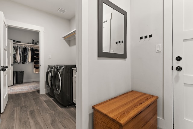 washroom featuring dark hardwood / wood-style floors and washing machine and clothes dryer