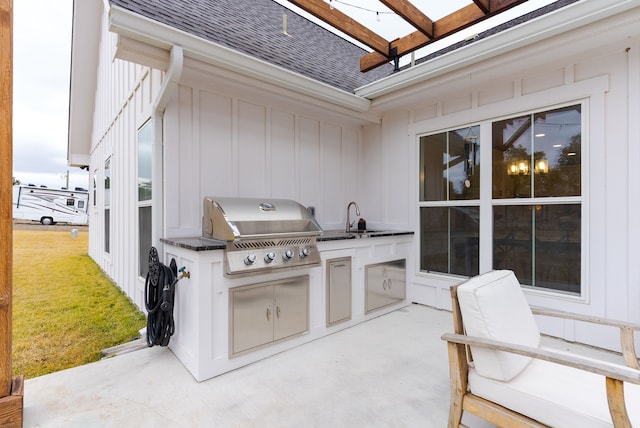 view of patio / terrace featuring grilling area, sink, and exterior kitchen