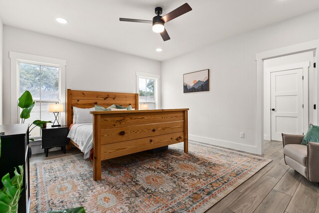 bedroom featuring multiple windows and ceiling fan