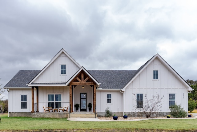 modern farmhouse style home with a porch and a front yard