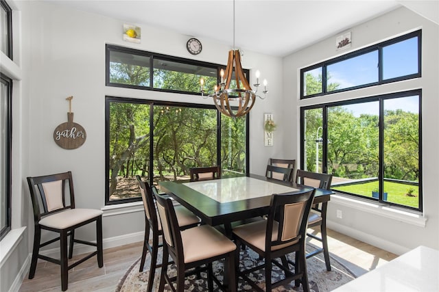 dining room with a notable chandelier and light wood-type flooring