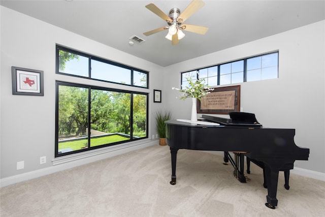 miscellaneous room with a healthy amount of sunlight, ceiling fan, and light colored carpet