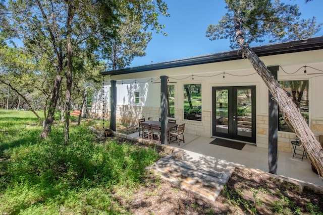 rear view of property with a patio area and french doors