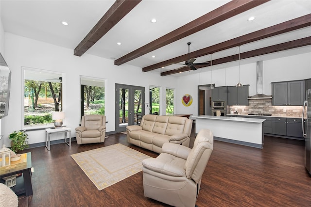 living room featuring ceiling fan, dark hardwood / wood-style flooring, and beamed ceiling