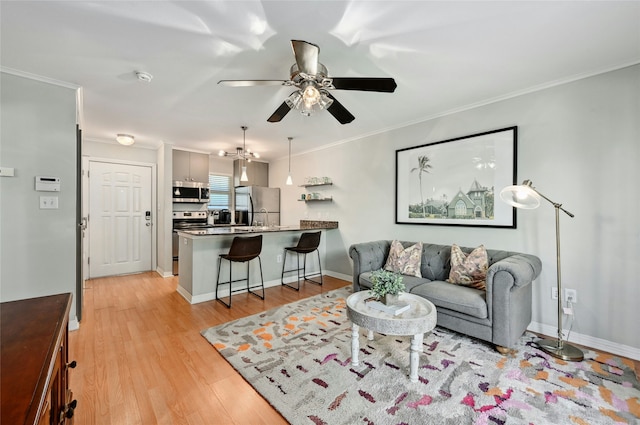 living room with ceiling fan, light hardwood / wood-style floors, and crown molding