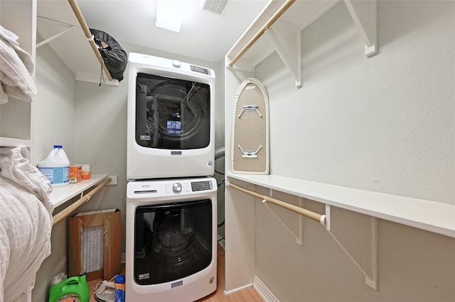 laundry area with stacked washer / dryer