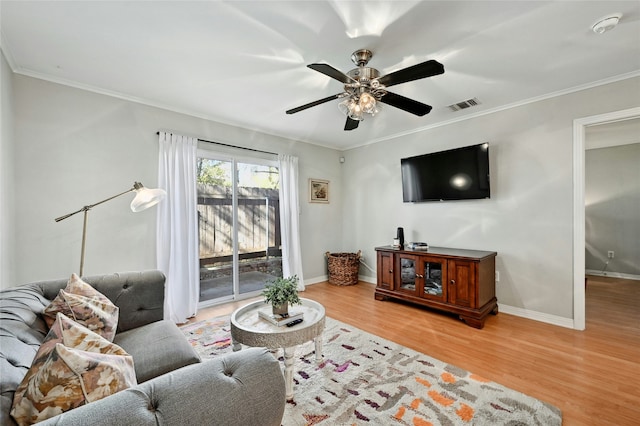 living room with ceiling fan, light hardwood / wood-style floors, and ornamental molding